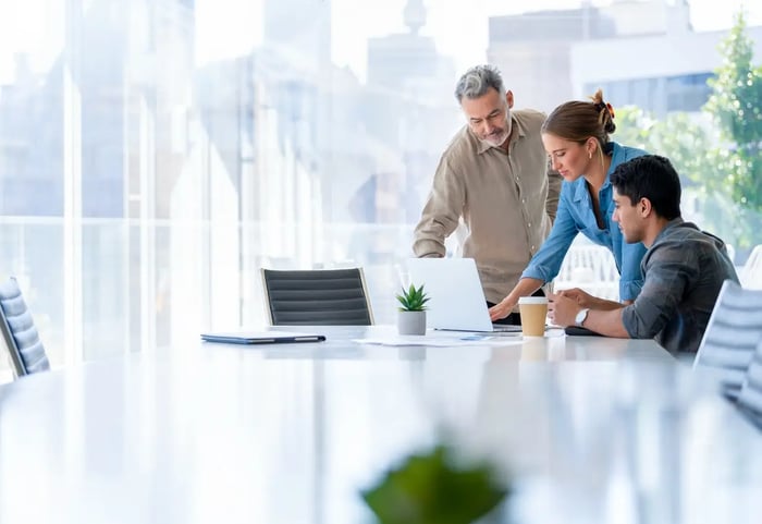  business people at a conference table 